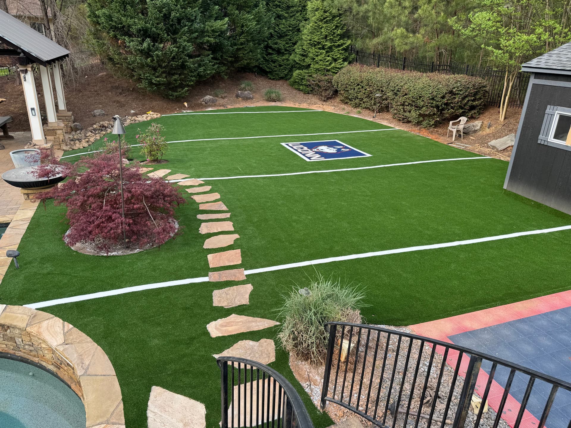 Backyard Mini Football Field with Custom UConn Logo Turf image